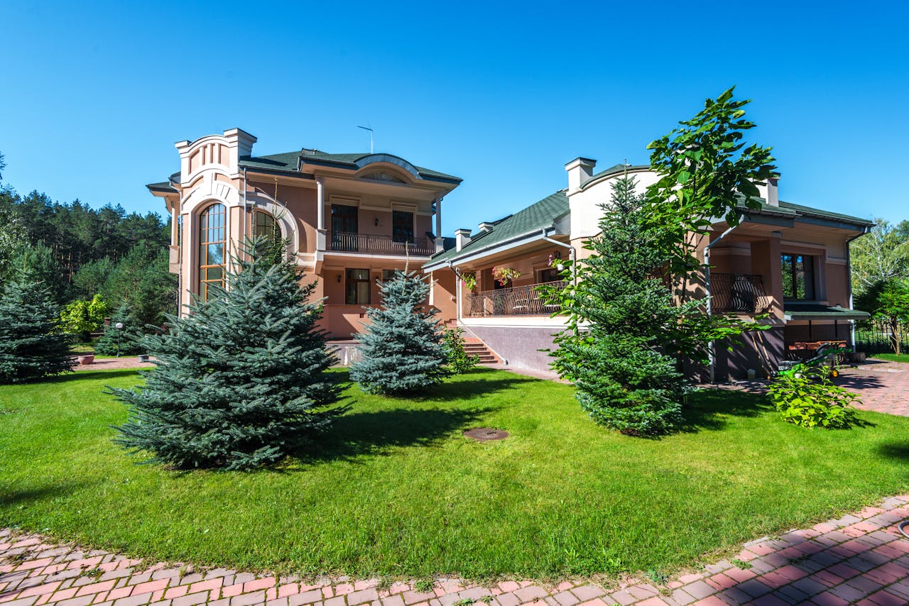 Elegant suburban estate with modern architecture amidst lush greenery, captured on a sunny day.